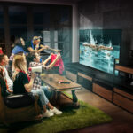 Group of friends watching TV, match, championship, sport games. Emotional men and women emotional cheering for favourite swimmer of country. Concept of friendship, sport, competition, emotions.